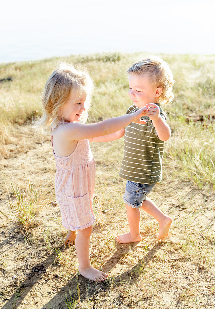 Little Kids Dancing in a field by the lake